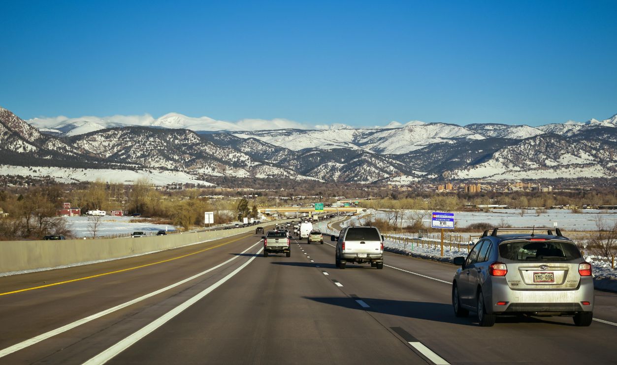 Vehicles on Concrete Road with Mountain View