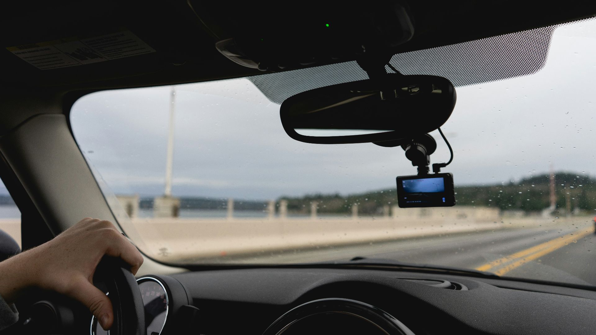 a person driving a car on a highway