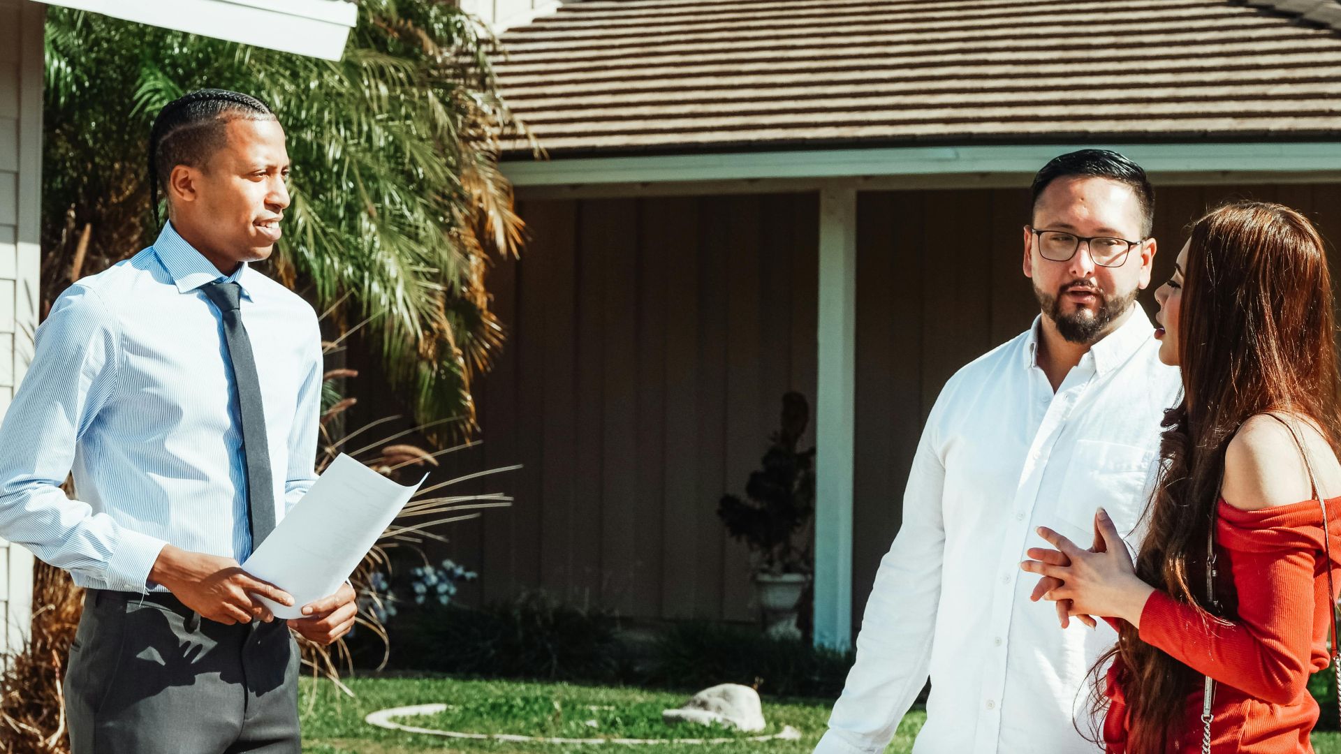 A real estate agent showing a house to a couple, discussing options.