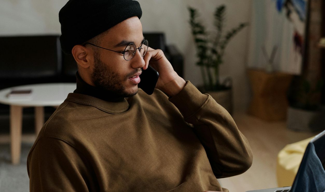 Man in Brown Long Sleeve Shirt Sitting on a Chair