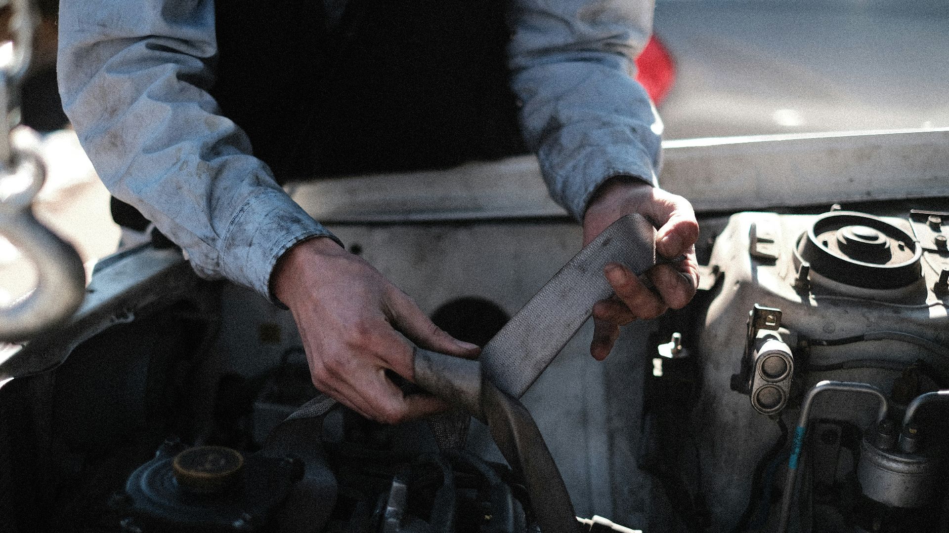a man is working on a car engine