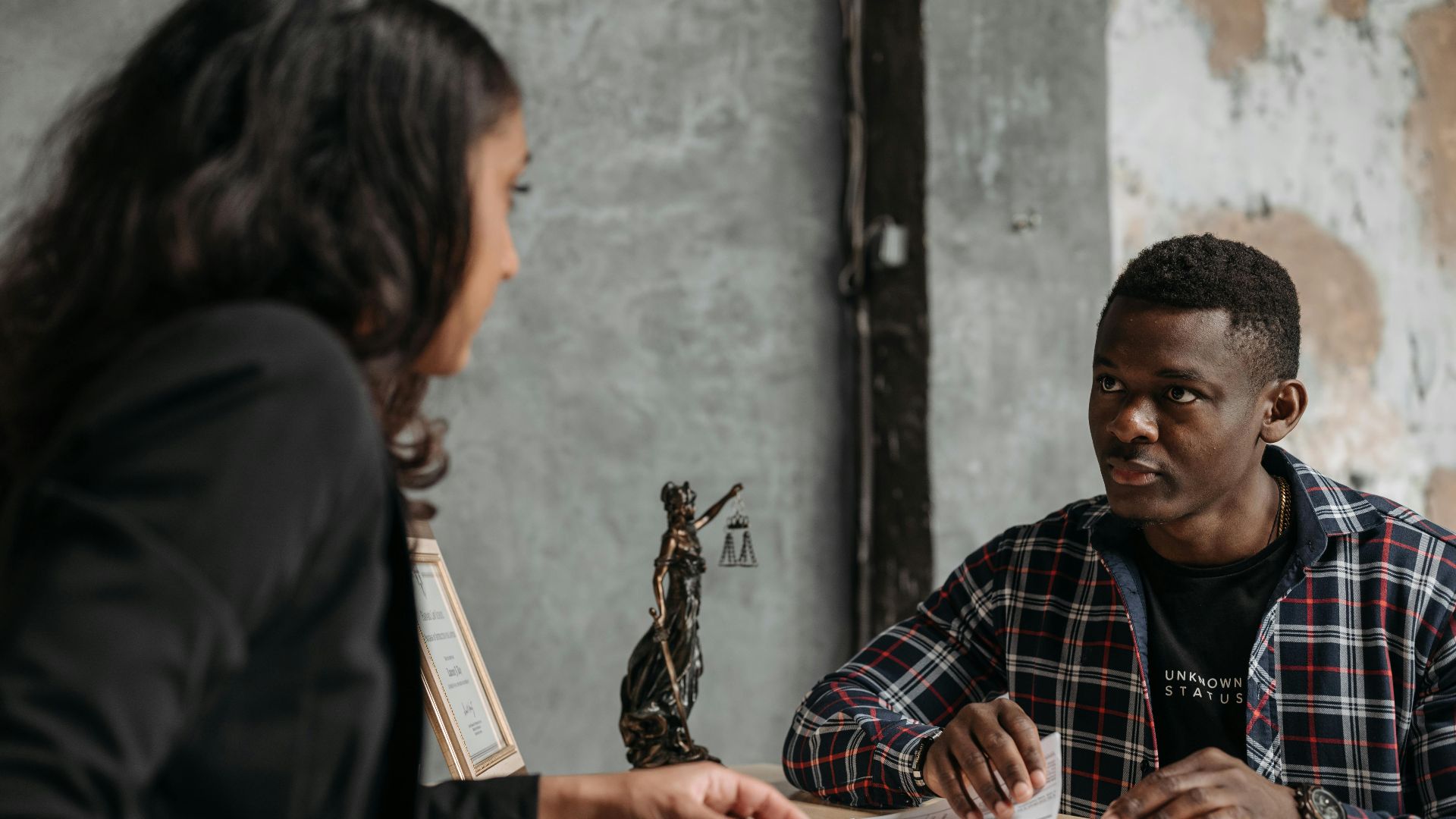 Business meeting between a lawyer and client in a professional office setting.