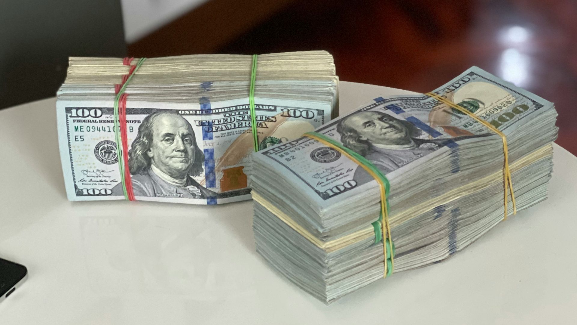 a stack of money sitting on top of a white table