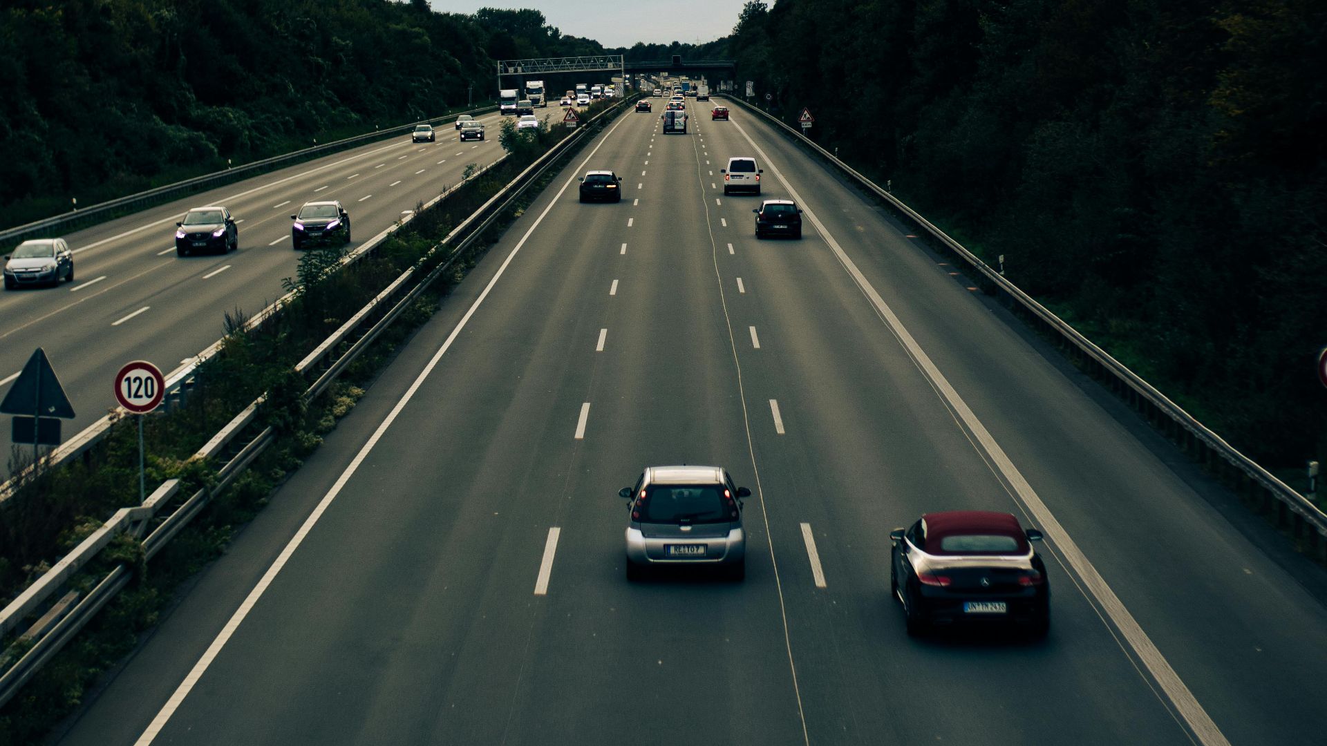 An aerial view of busy highway traffic in Dortmund, Germany with lush greenery.