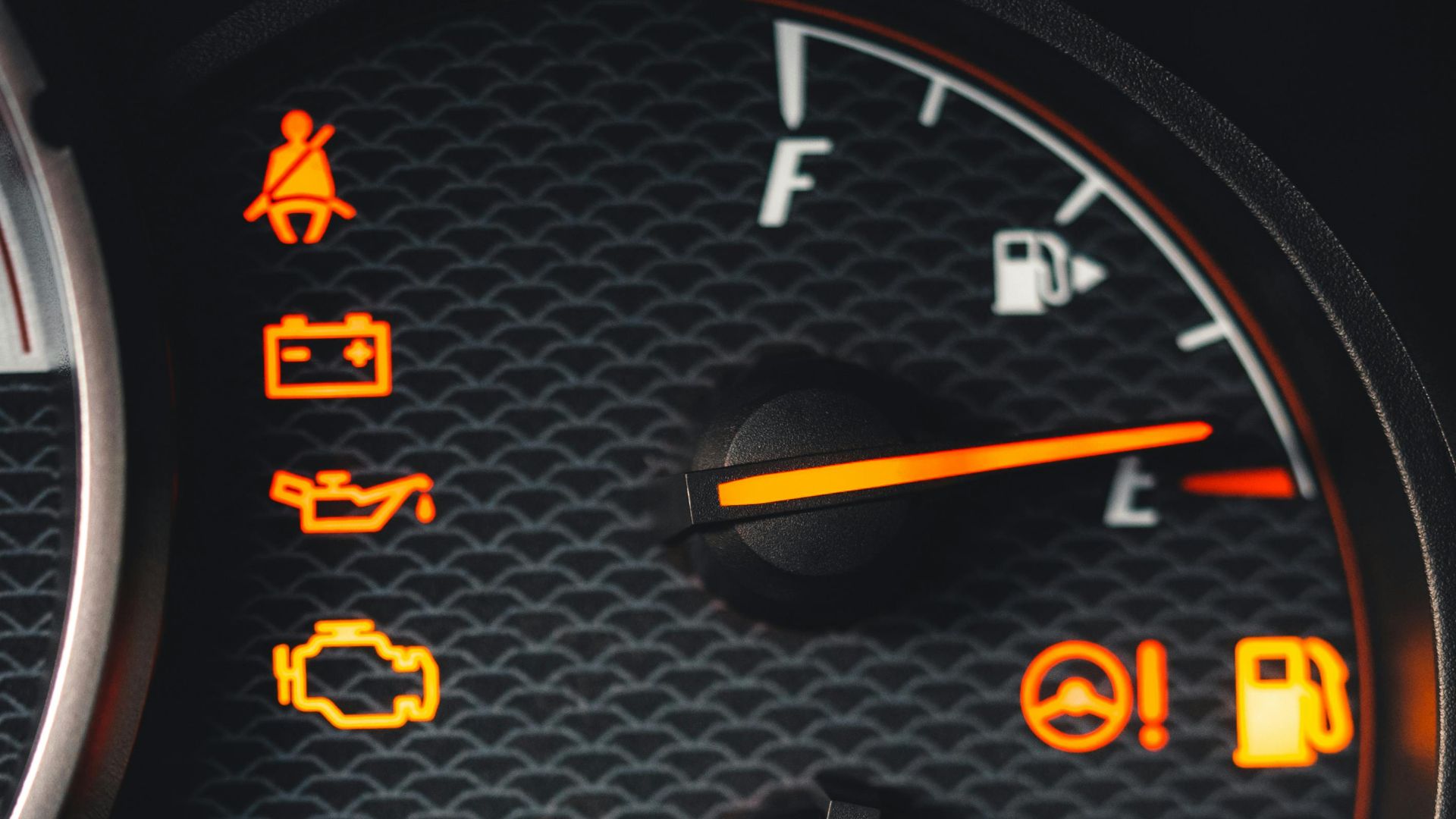 Detailed close-up of car dashboard with various warning lights illuminated.