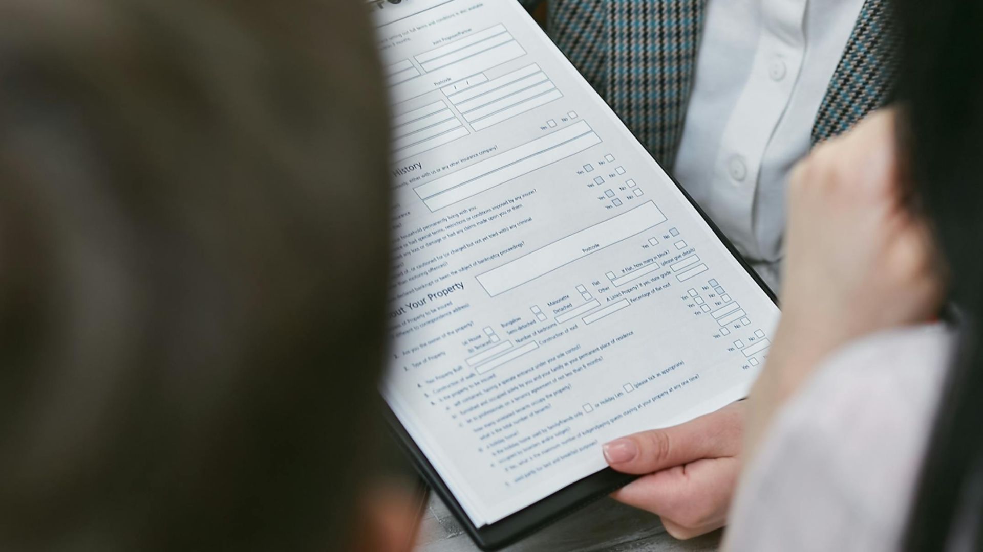 Close-up of professionals discussing a legal contract during a business meeting.