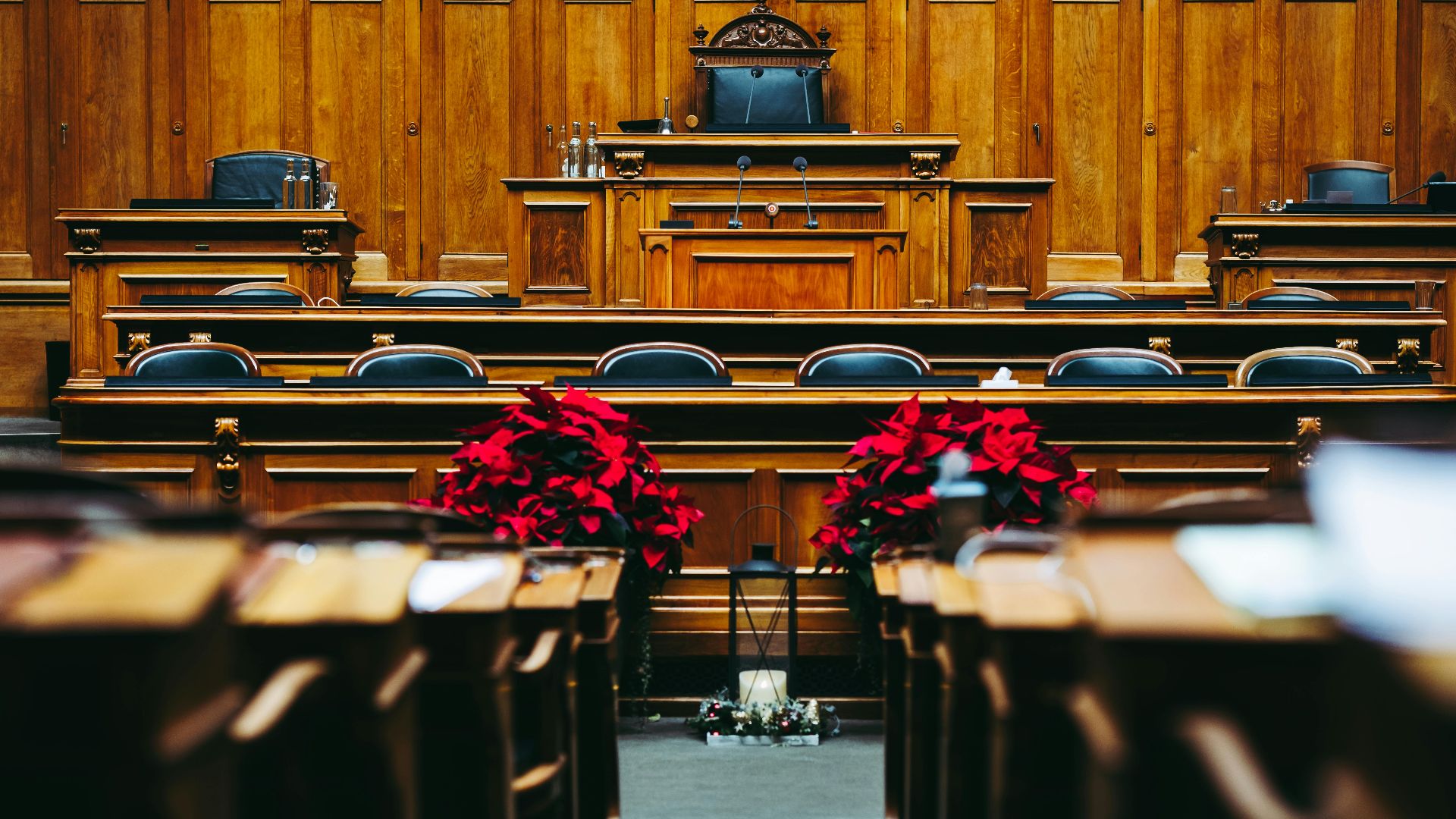 Spacious and elegant wooden courtroom with empty seats, located in Bern, Switzerland.