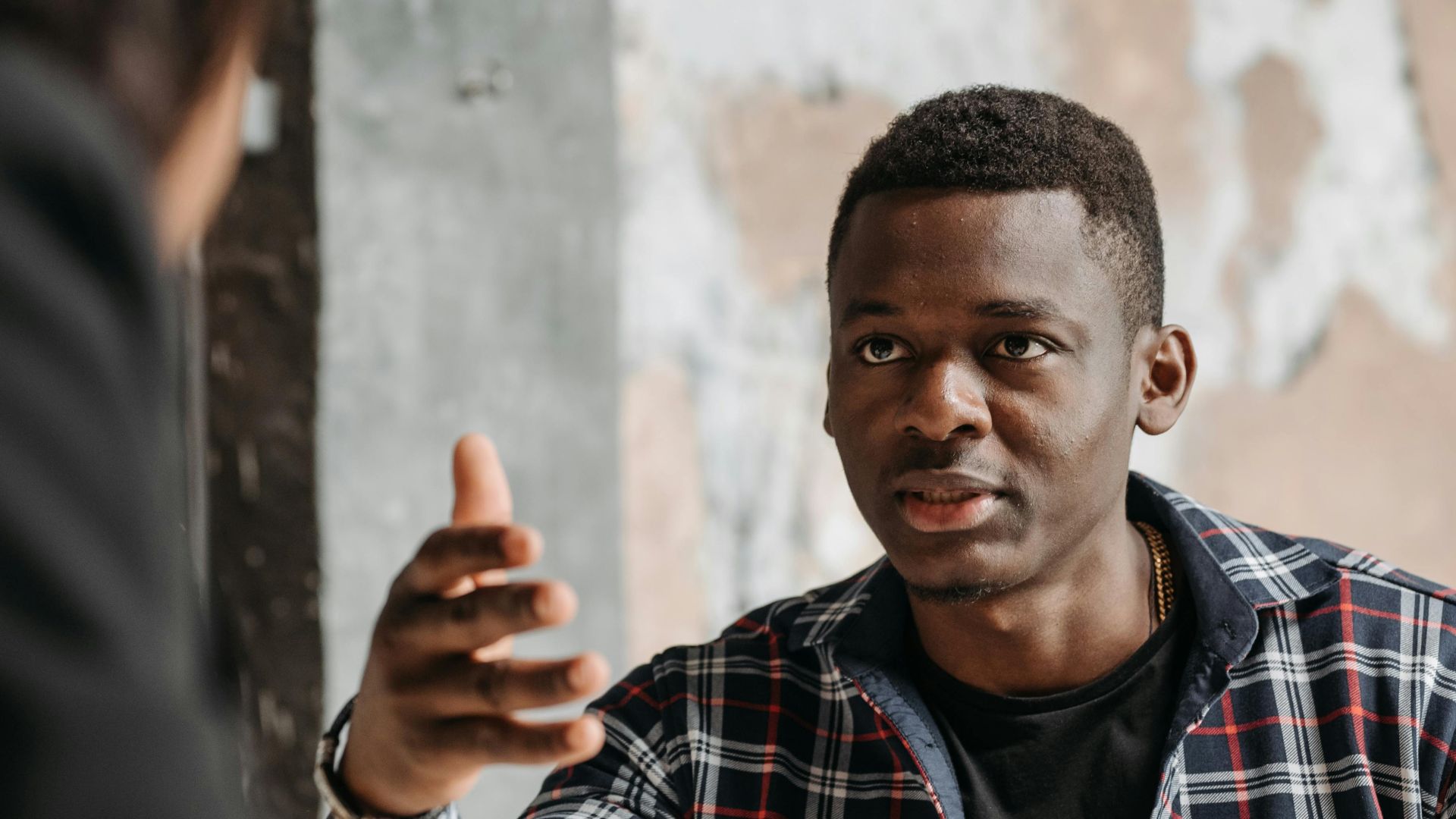Business interaction between two adults discussing documents in a modern office.