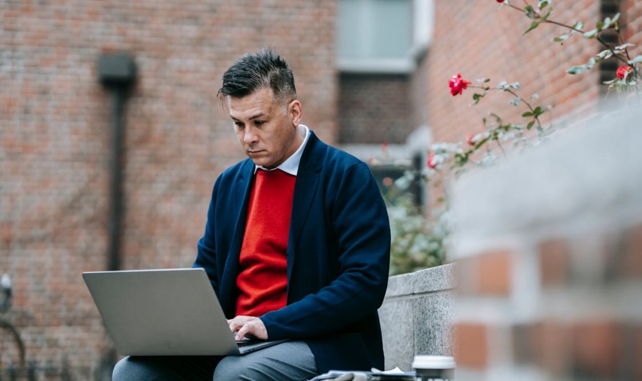 Photo Of Man Busy Working On His Grey Laptop