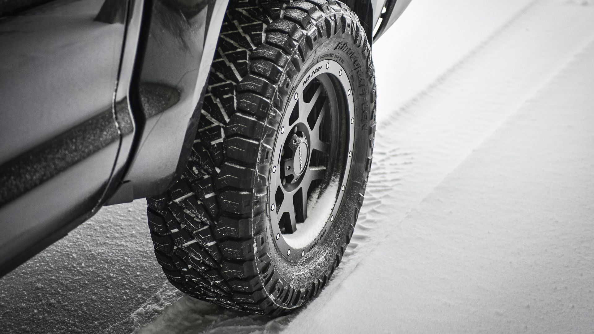 grayscale photo of car wheel