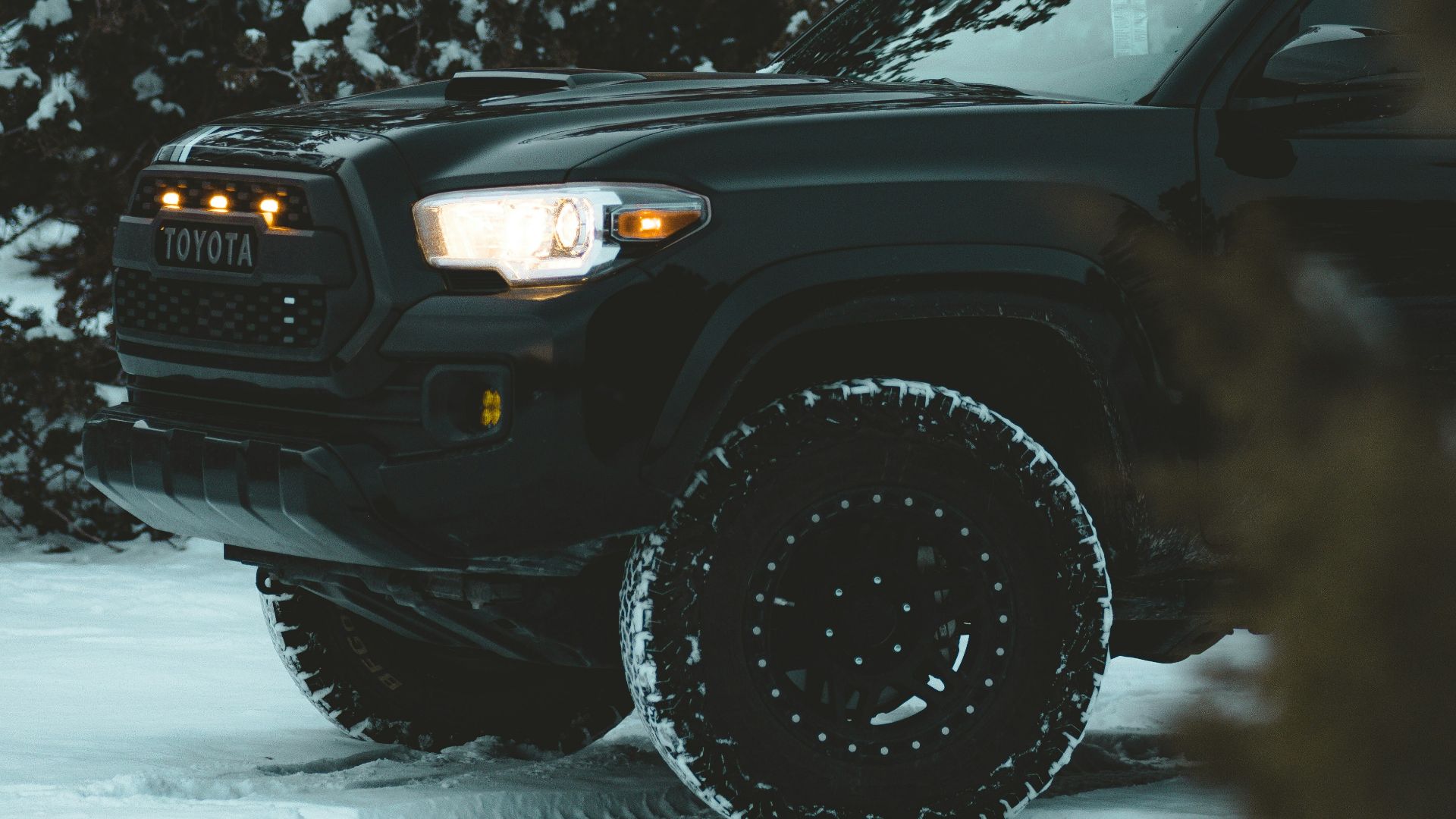 a black truck is parked in the snow