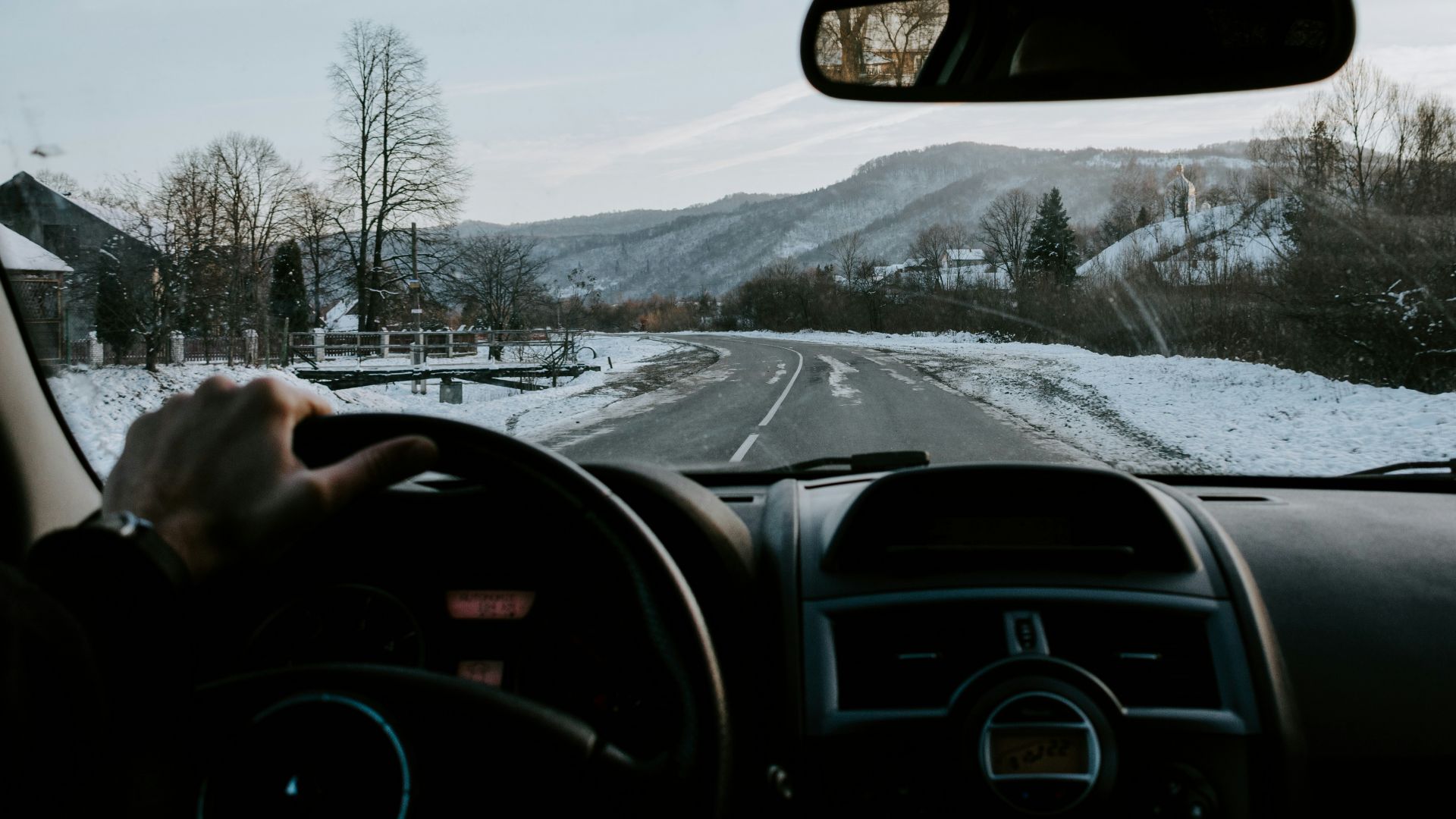 person holding steering wheel