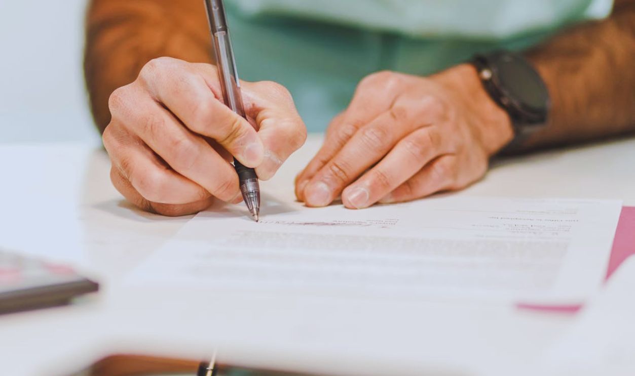 A Person Writing on White Paper