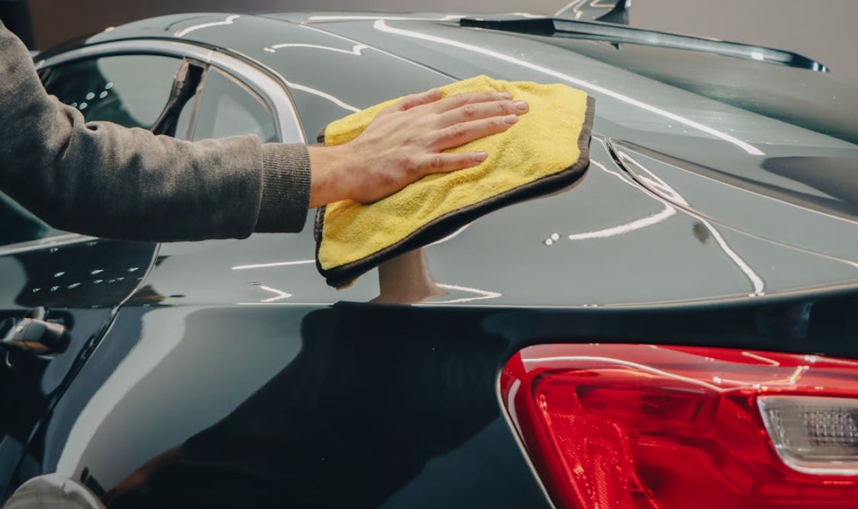 Hand Wiping a Car with a Cloth