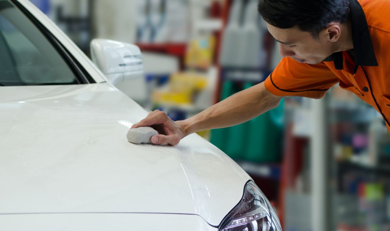 Hand Polishing By Clay Bar And Clay Lubricant For Remove Dirt On Car Surface.