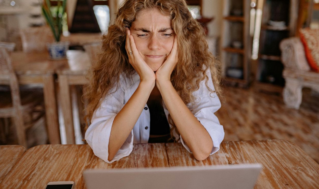 Woman in White Shirt Sitting by the Table