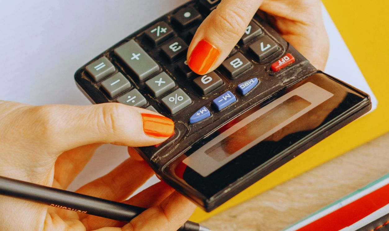 A Person Using a Calculator in Computing