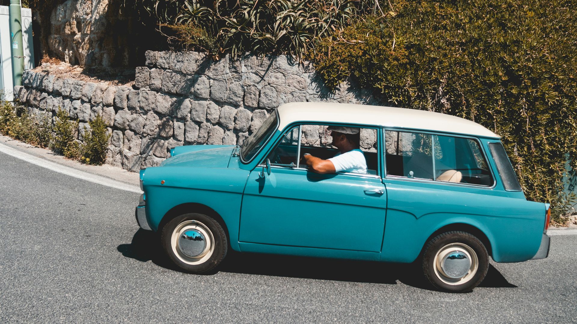 man riding teal vehicle