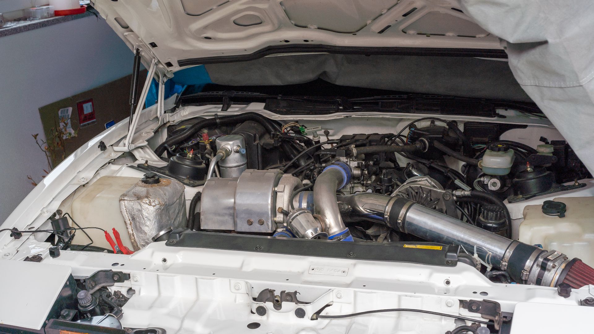 1989 Pontiac Firebird Turbo Trans Am engine bay. Modified with LS1 MAF and larger air filter. Larger turbocharger is not visible.