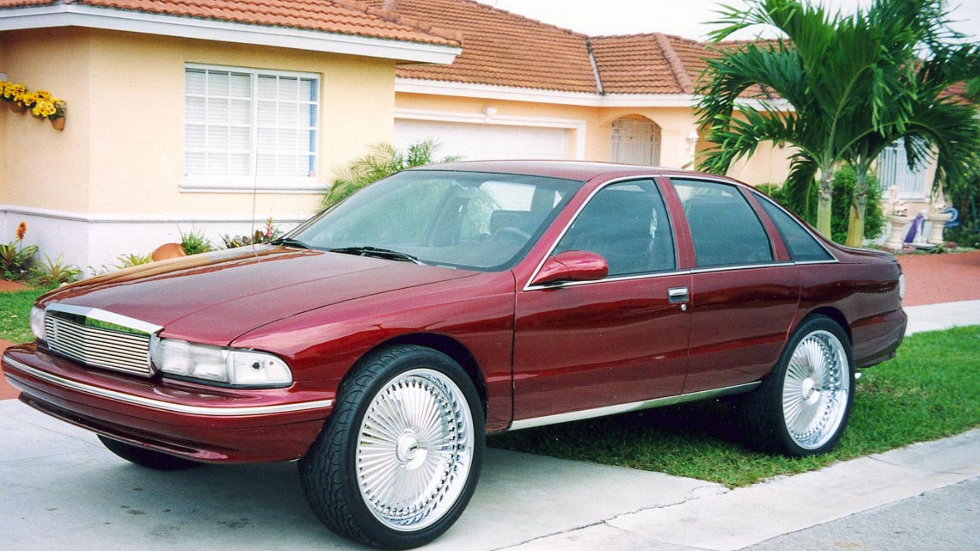 Customized 1995-1996 Chevrolet Caprice. Those wheels are way bigger than dubs, but the owner and/or photographer probably knows the size better.