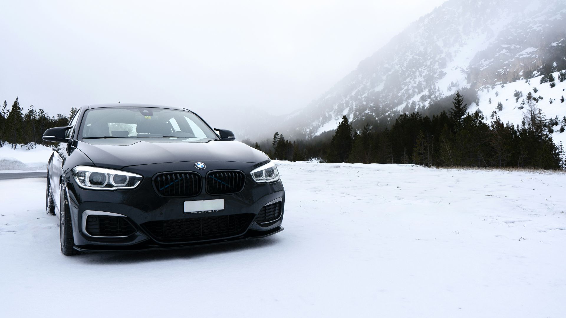 A black car parked on a snowy road