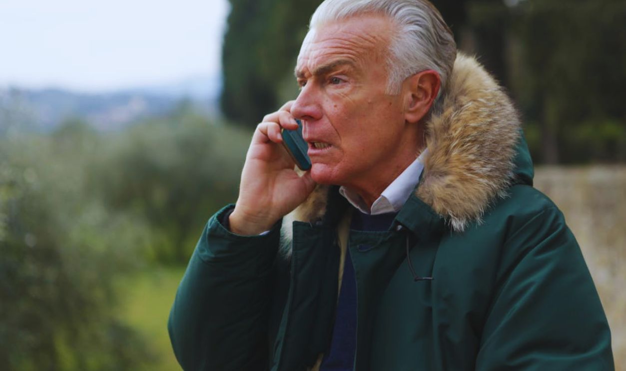 Man in Green Jacket Holding Phone
