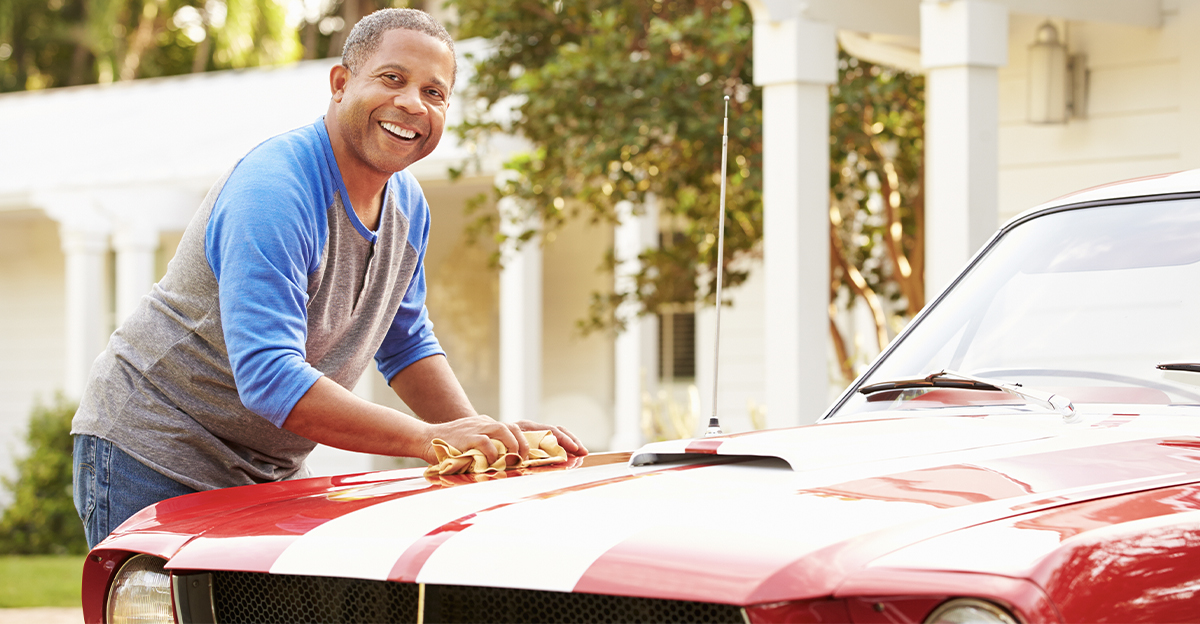 Retired Senior Man Cleaning Restored Car