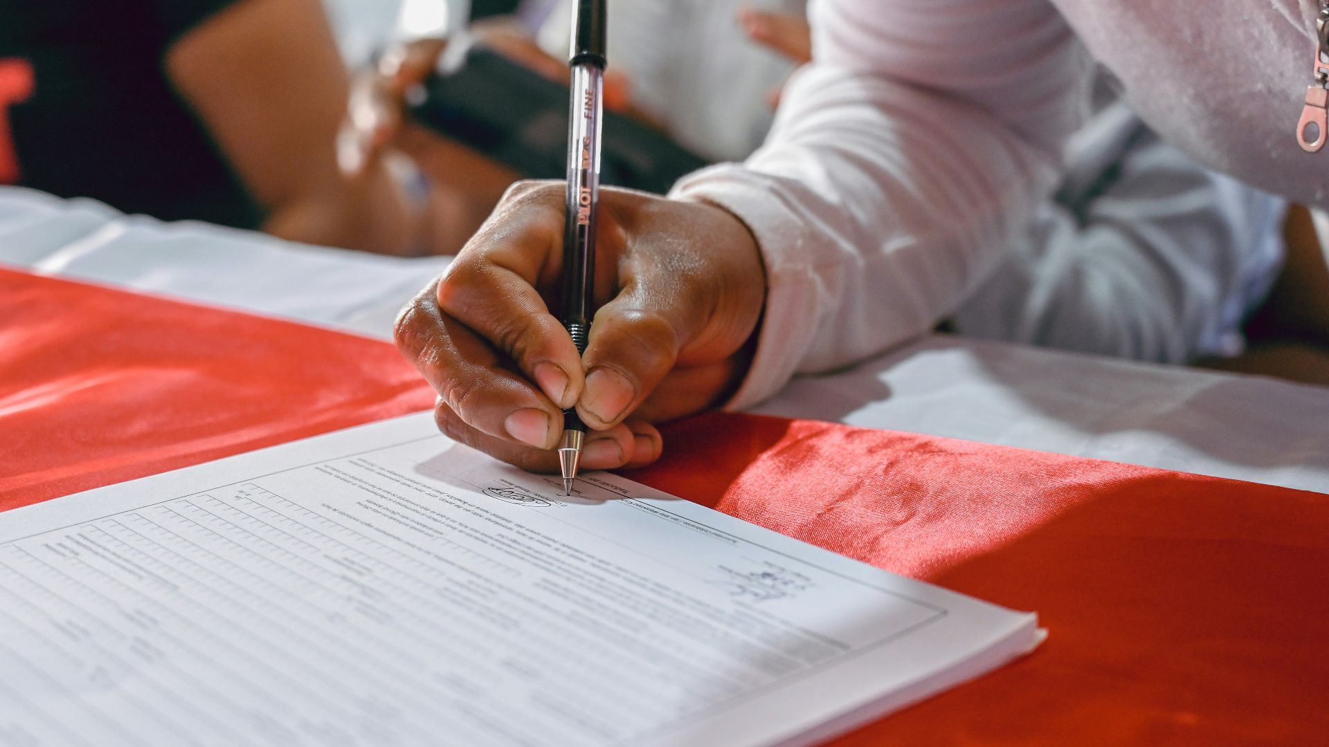 a person writing on a piece of paper
