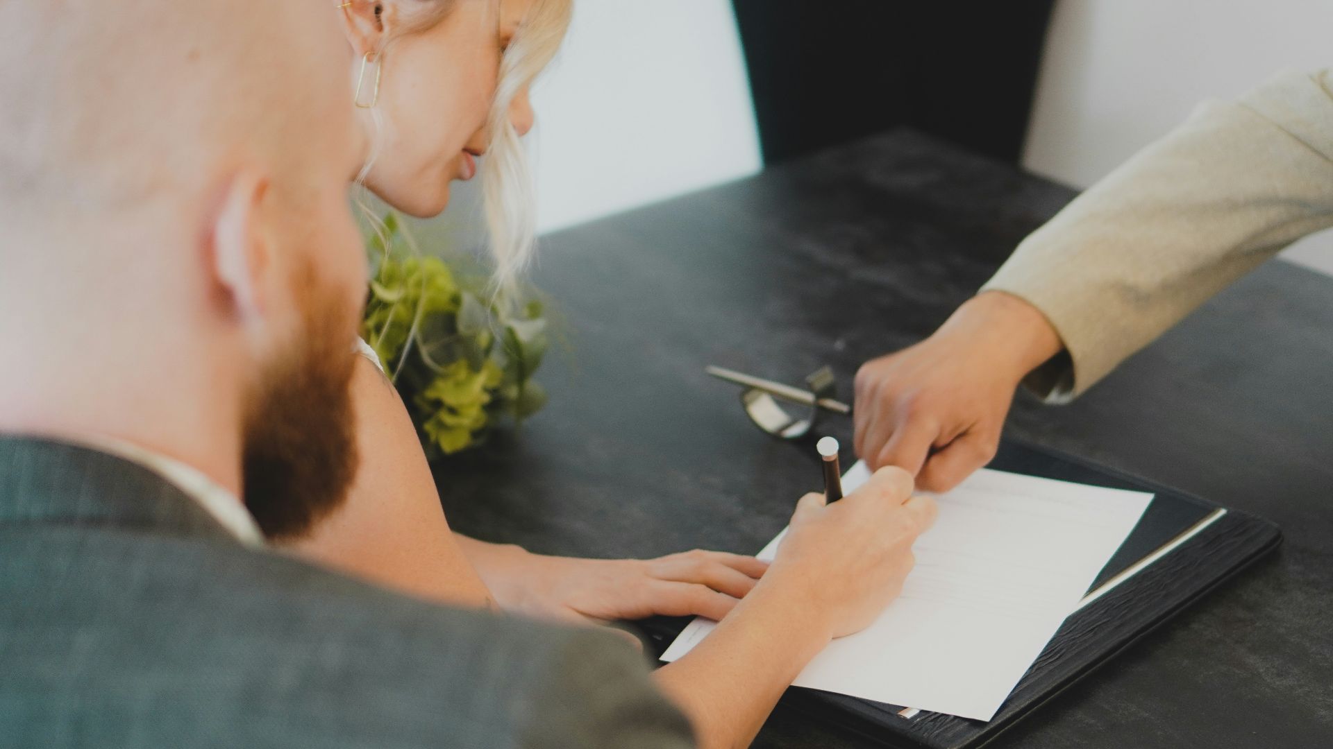 a woman showing a man something on a tablet