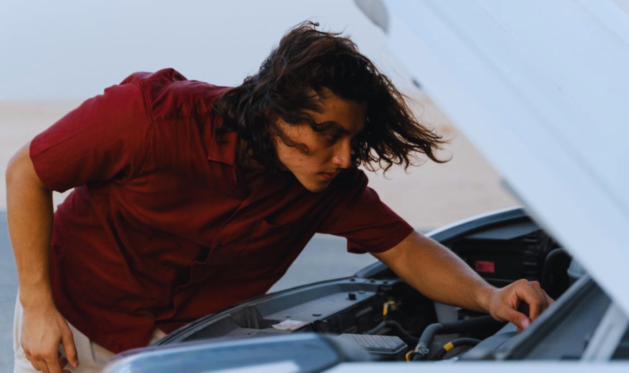 A Man Checking on his Car