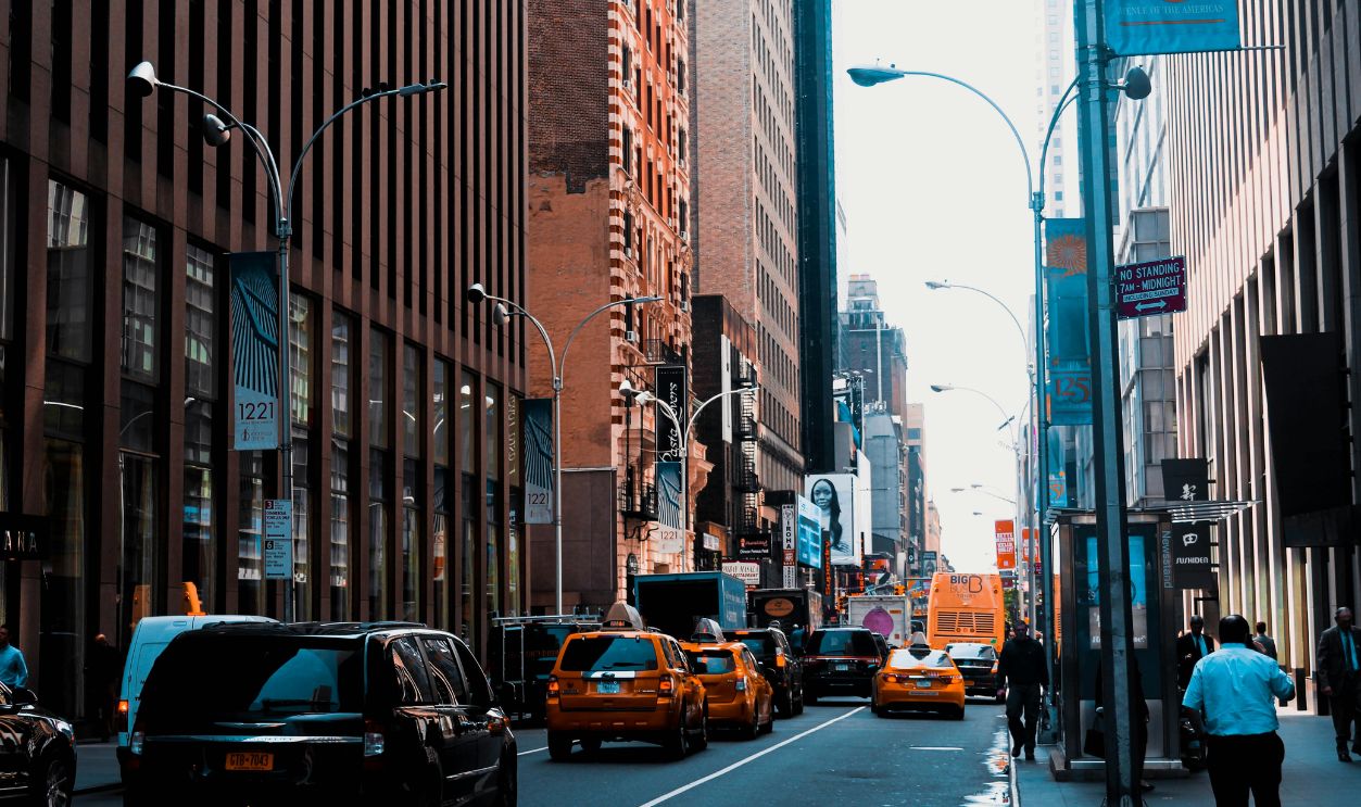 Photo of Cars on Road Near Buildings