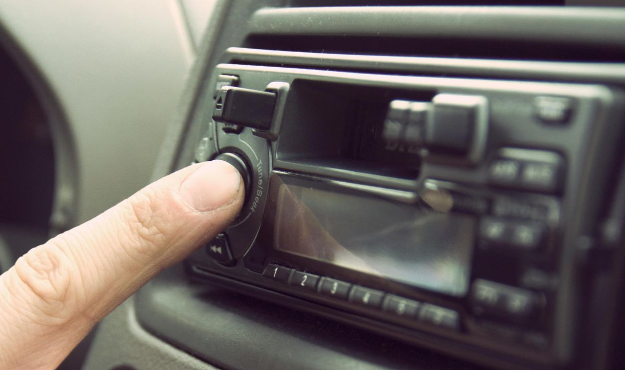 Person Touching 1-din Head Unit Button