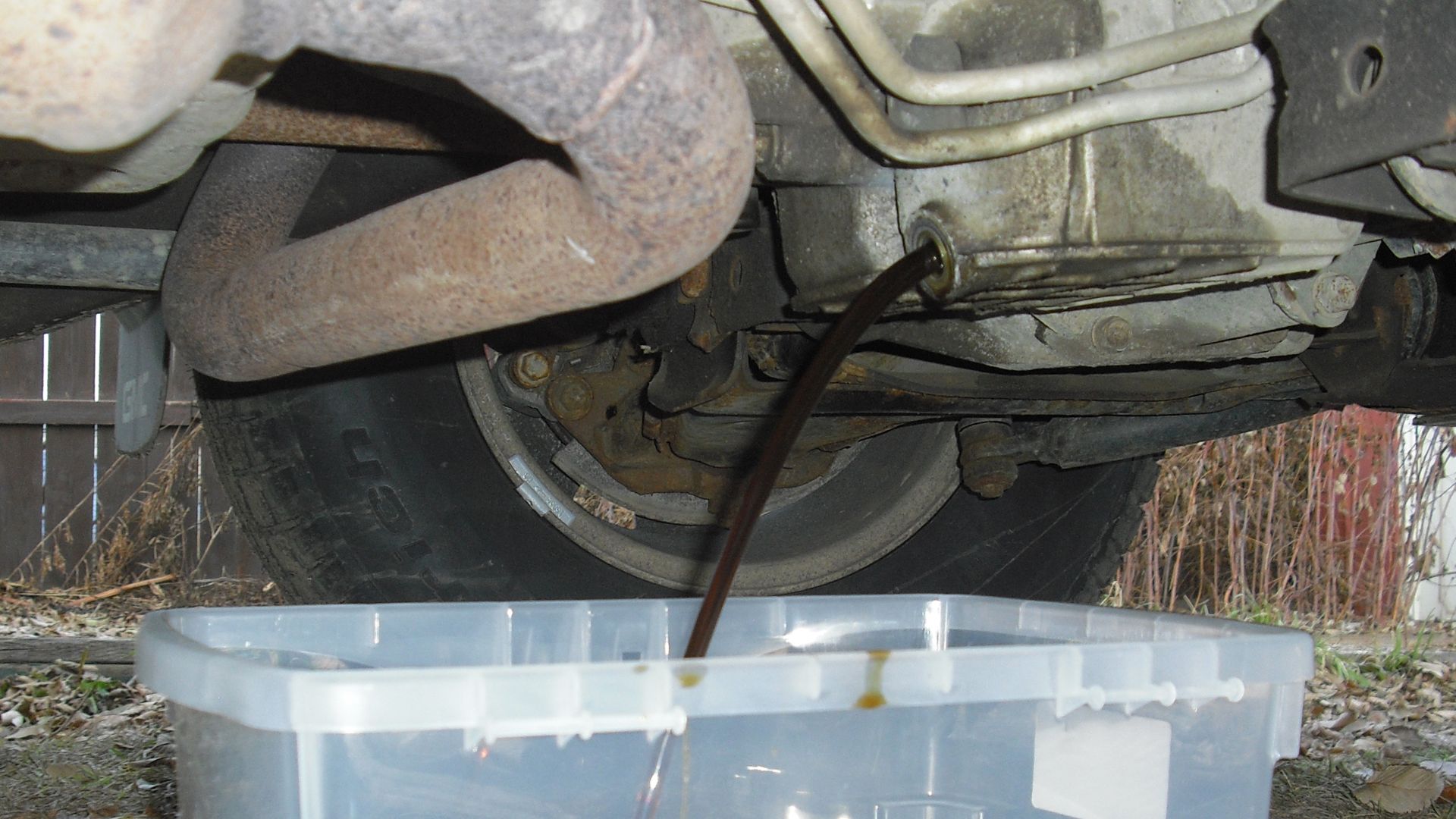 Oil being drained from a GMC Sport Utility Vehicle.