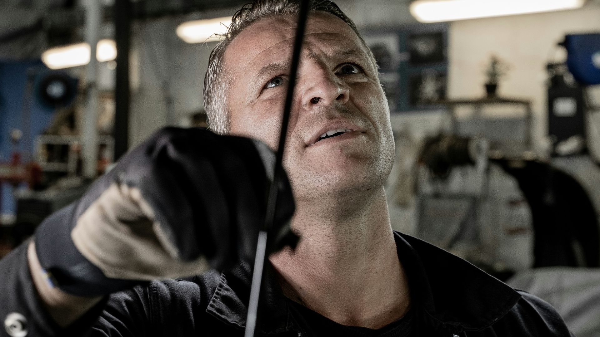a man working on a car in a garage