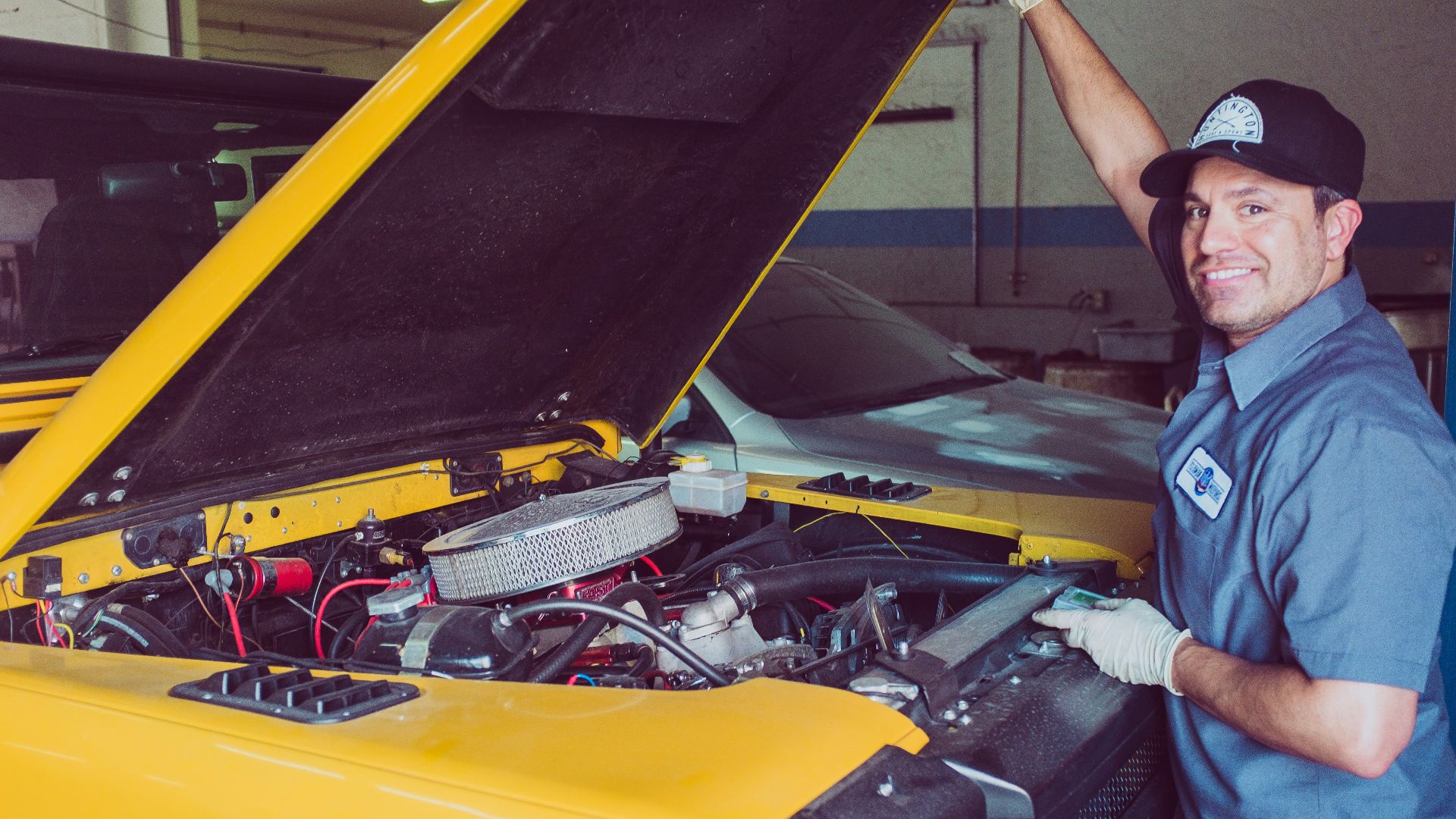 man holding open-wide car trunk