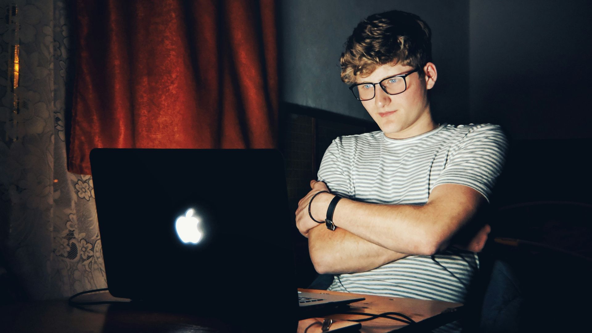 man looking at turned on MacBook