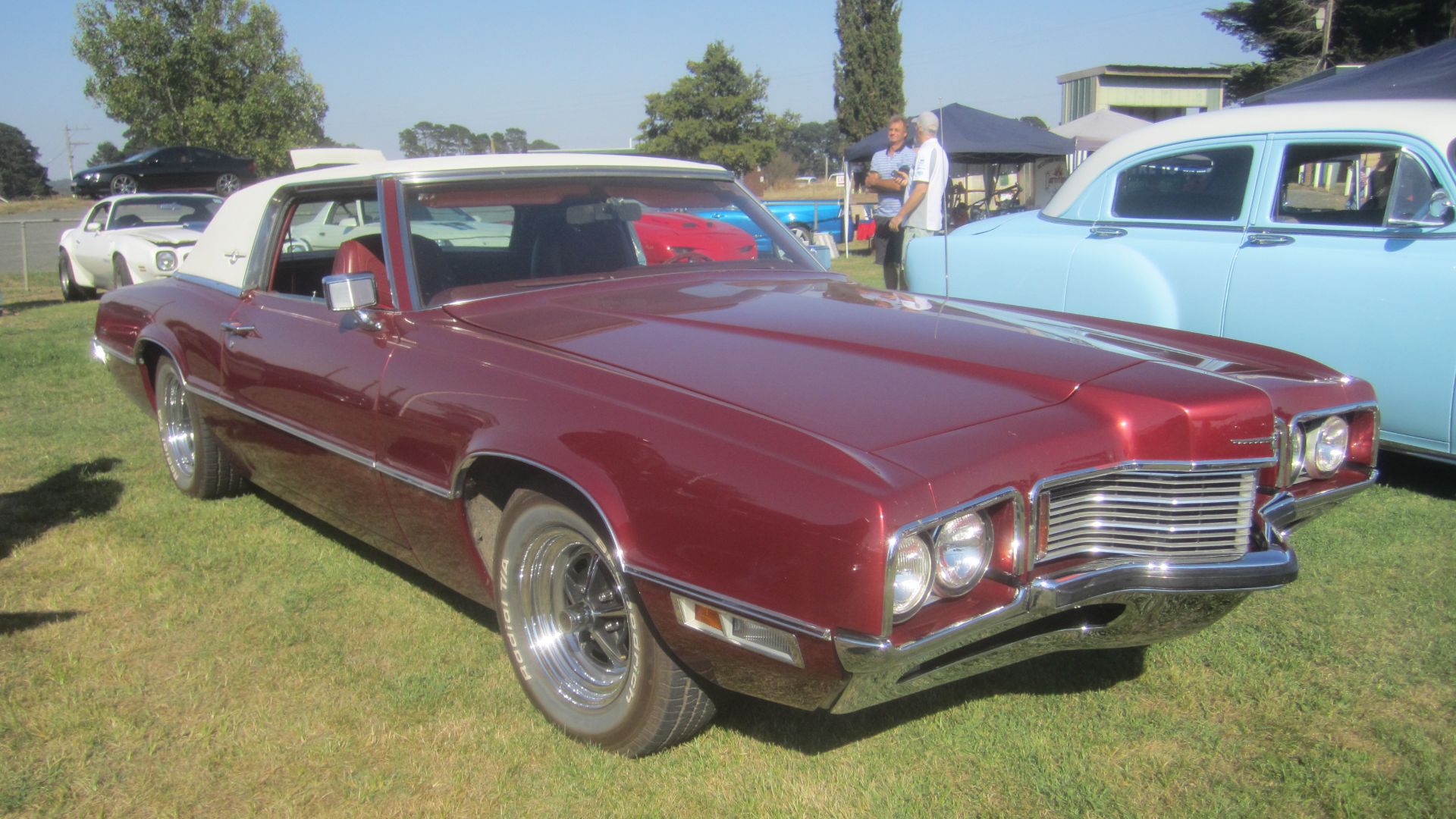 Burgundy Fire. 
Fords personal luxury car,  the 5th generation built from 1967 to 1971.The shape was restyled and was longer, so as not to compete with the Mustang. 
In 1970 the Thunderbird was stylistically updated with the addition of a large, bird's beak-style projection out of its grille. Offered in coupe or sports-back models, all 1970-1971 Thunderbirds had prominent angular lines on the hood leading to a jutting tip, that also formed the center of the grill work, that was not a too thinly disguised bird beak. 

Engine; 429 cu in V8