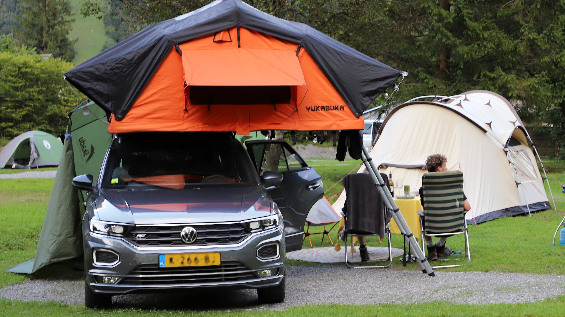 Tent on the car roof, mounted on a roof rack.