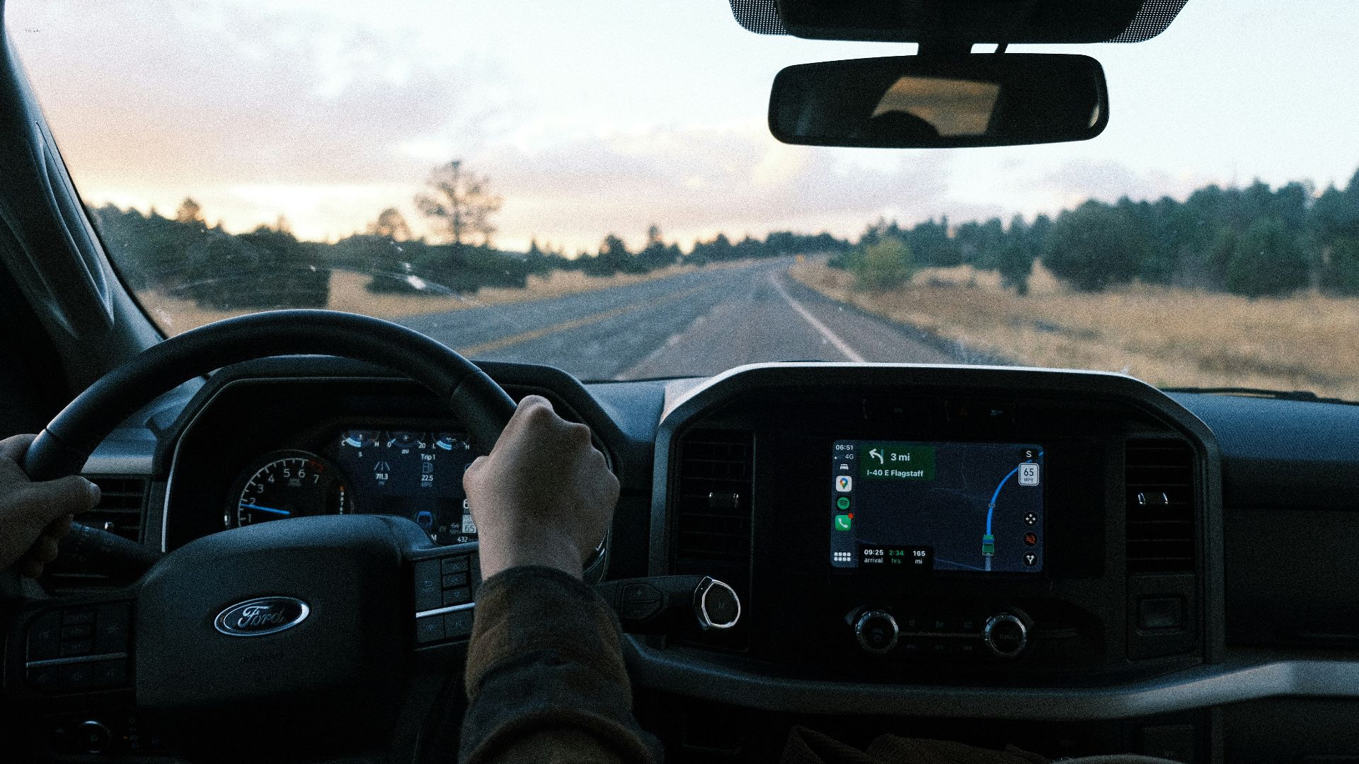 a person driving a truck on a rural road
