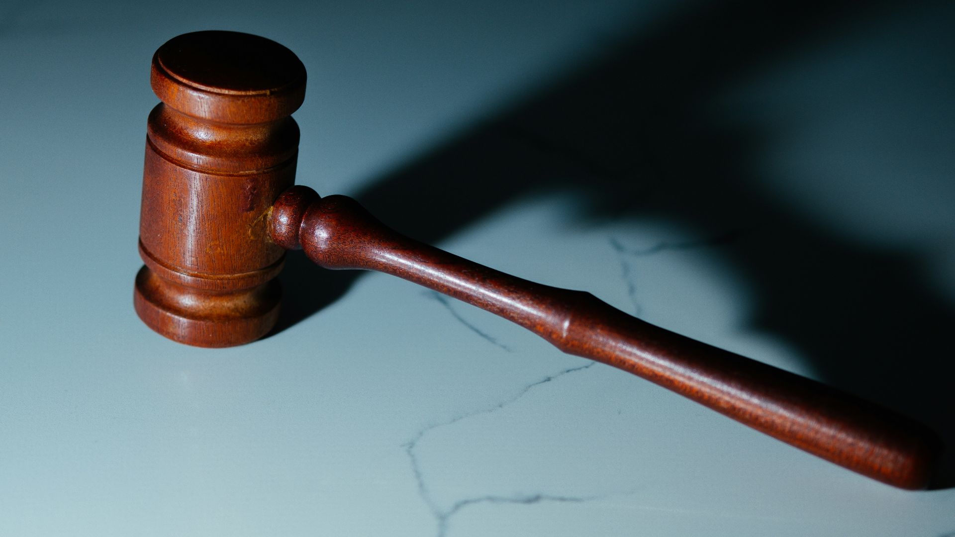 a wooden judge's hammer sitting on top of a table