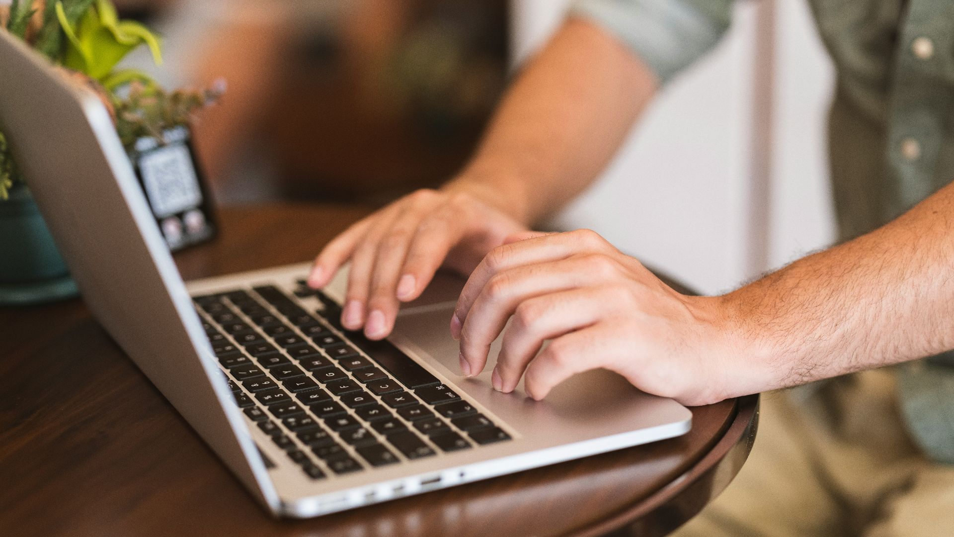 a man typing on a laptop