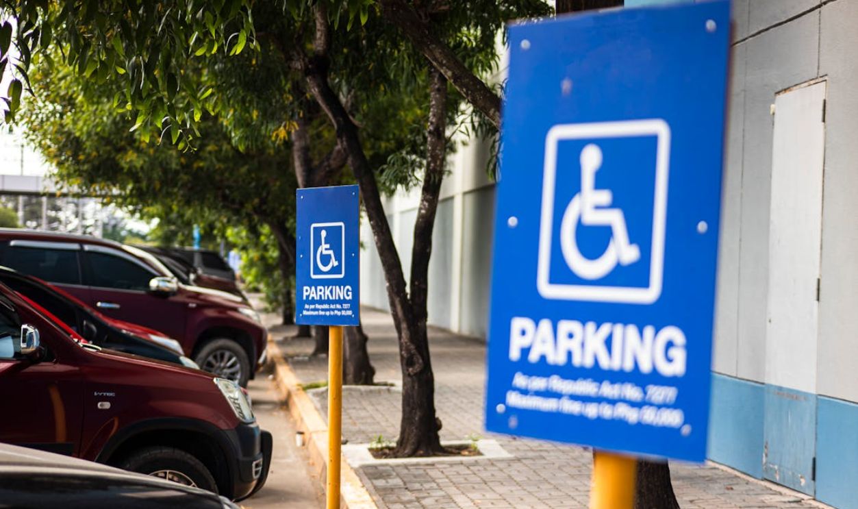 Disabled parking sign on street with transport