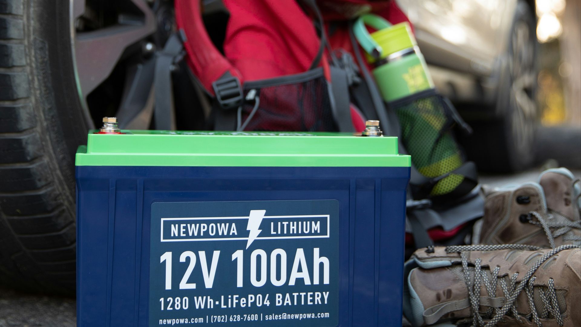 a car parked next to a pile of camping gear