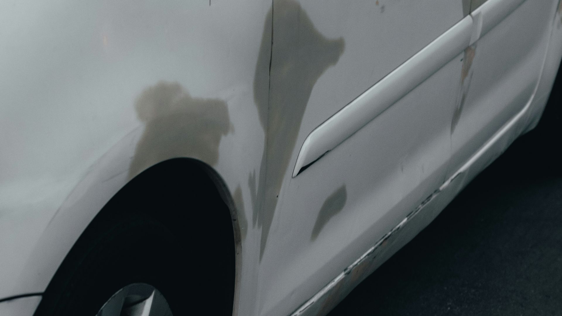 a white car parked in front of a building