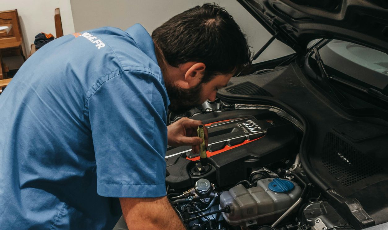 A Mechanic Checking the Engine of the Car