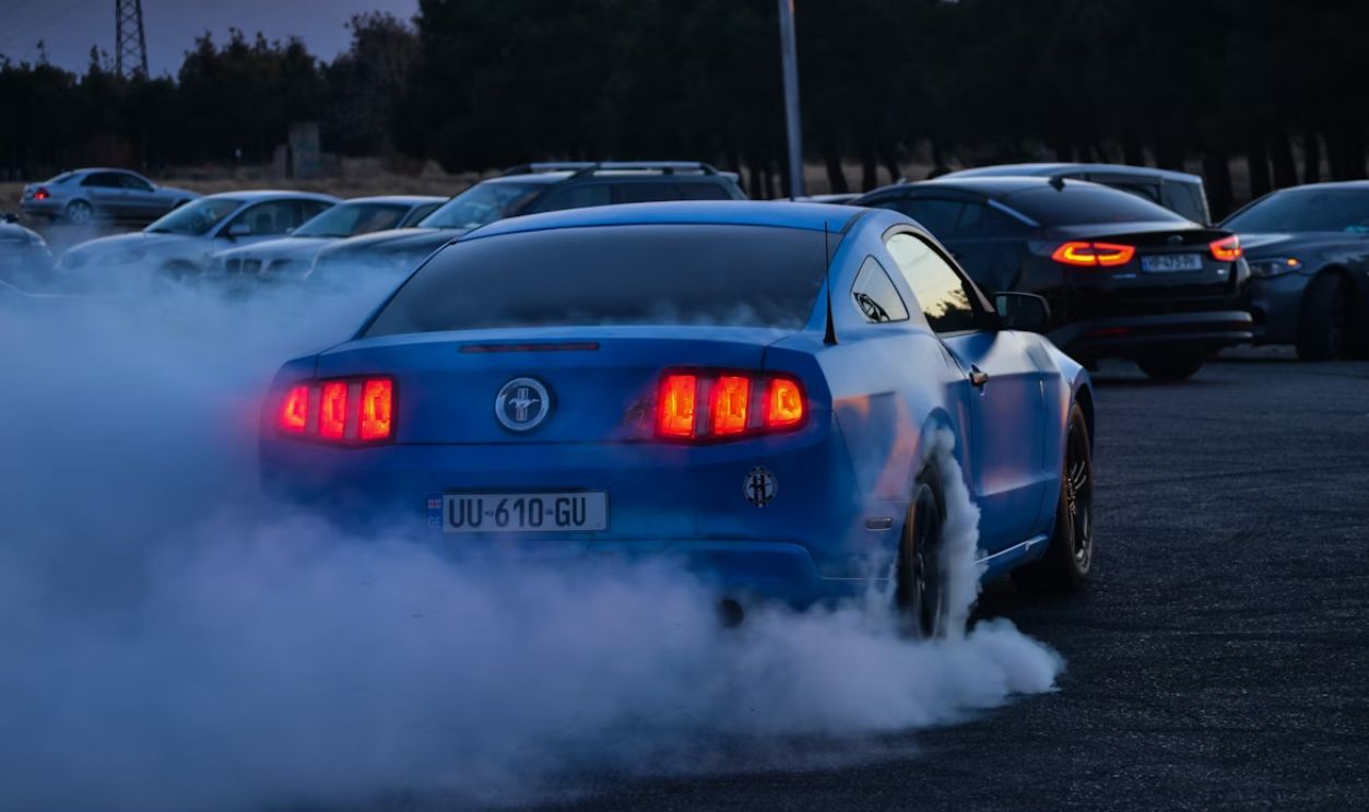 a blue car with a lot of smoke coming out of it