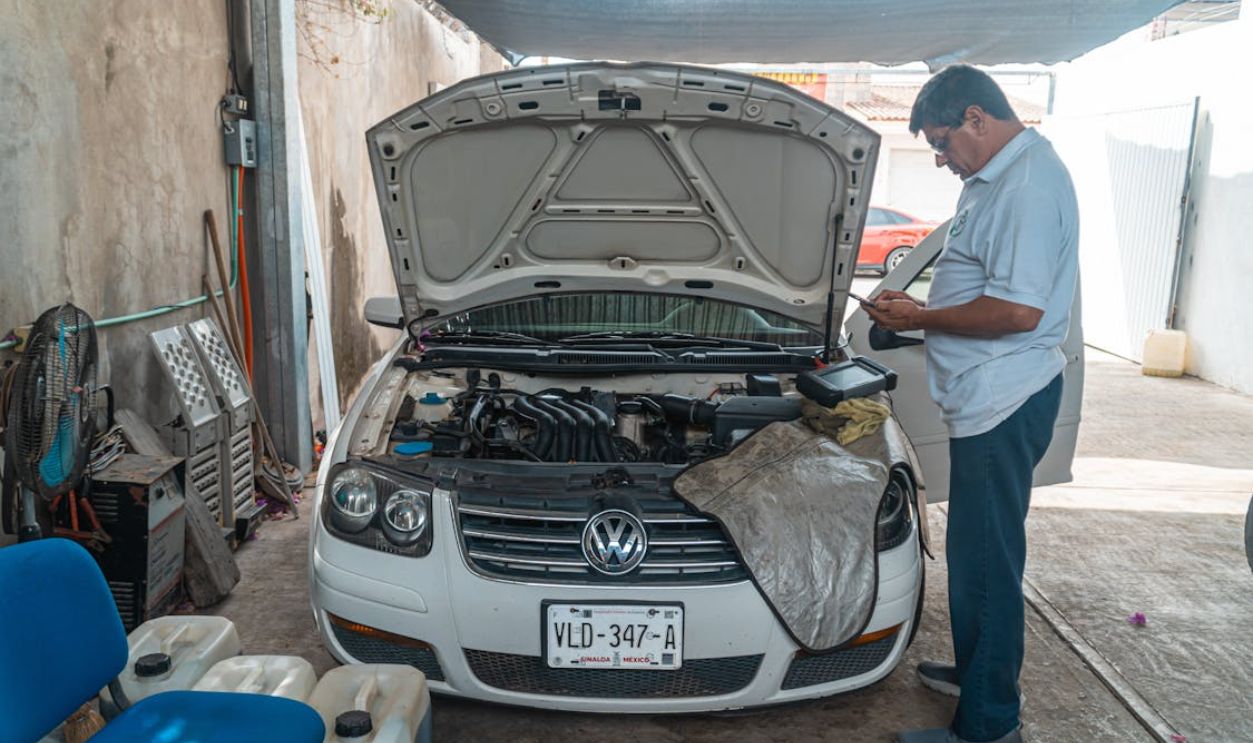 A Man Standing Beside the White Car