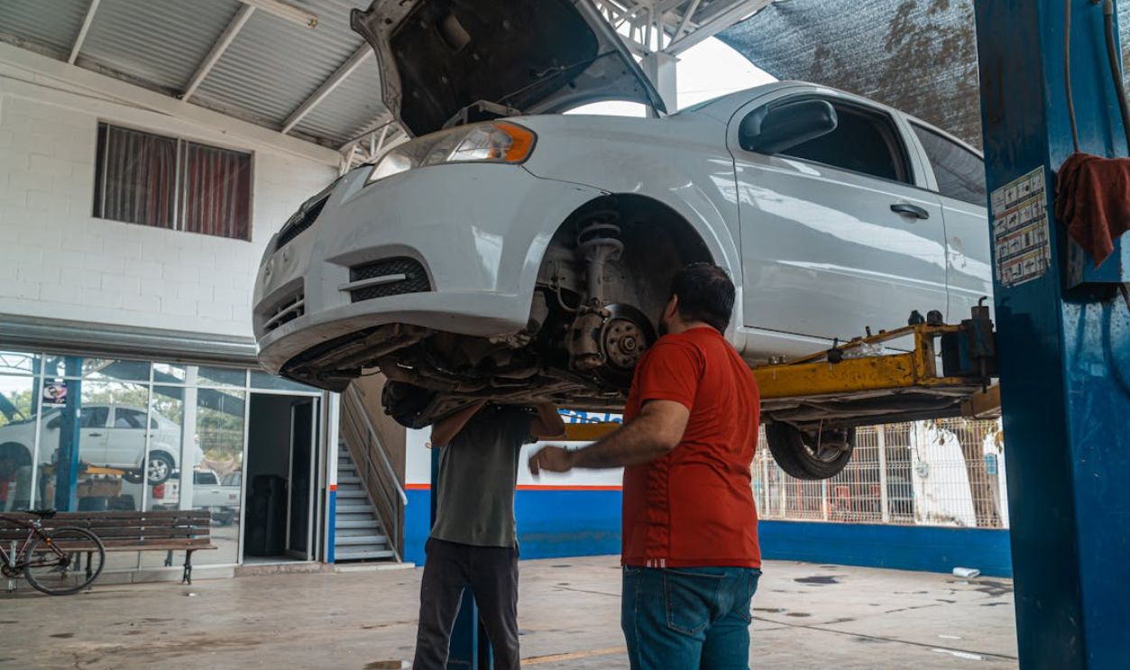 A Man Checking the White Car