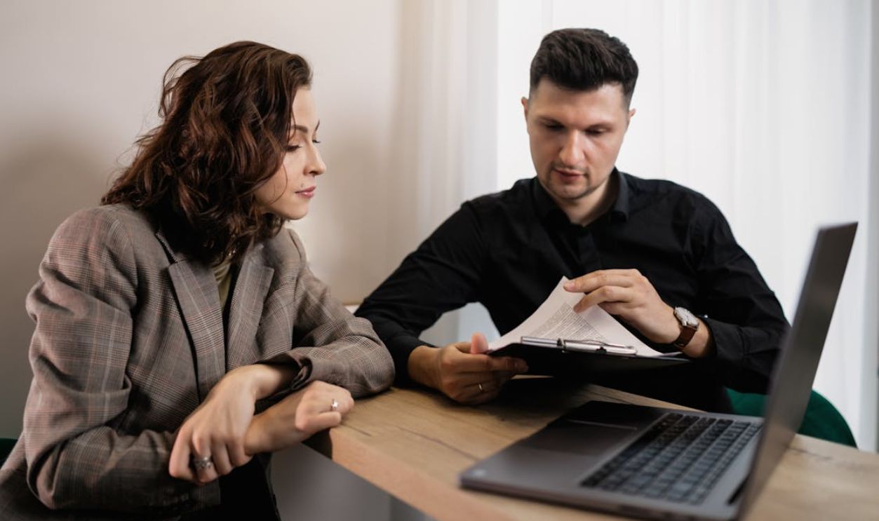 A Couple Reading a Document on a Clipboard
