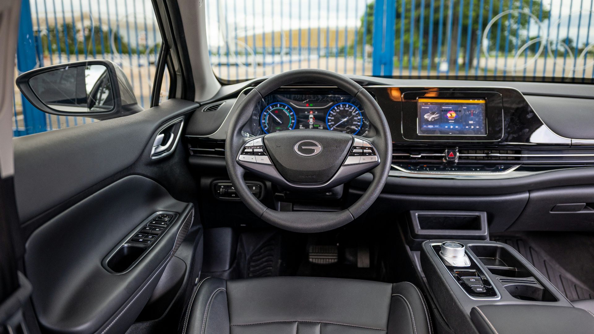 Interior view of a modern car dashboard and steering wheel.